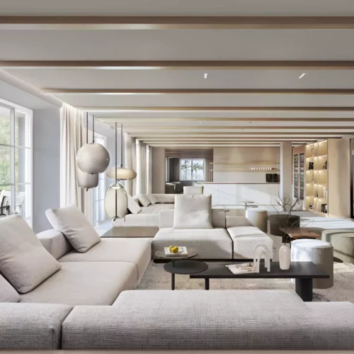 Salon spacieux et lumineux d'un resort boutique avec canapés beiges, cheminée moderne et grandes fenêtres donnant sur la