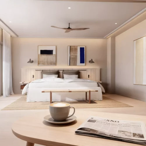 Chambre d'appartement boutique Maison Talmühle avec lit double, table basse, café et journal, ambiance spa et resort
