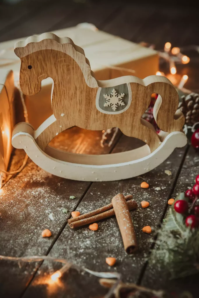 Wooden horse Christmas decoration with cinnamon sticks and fairy lights on a rustic wooden table at the Black Forest resort